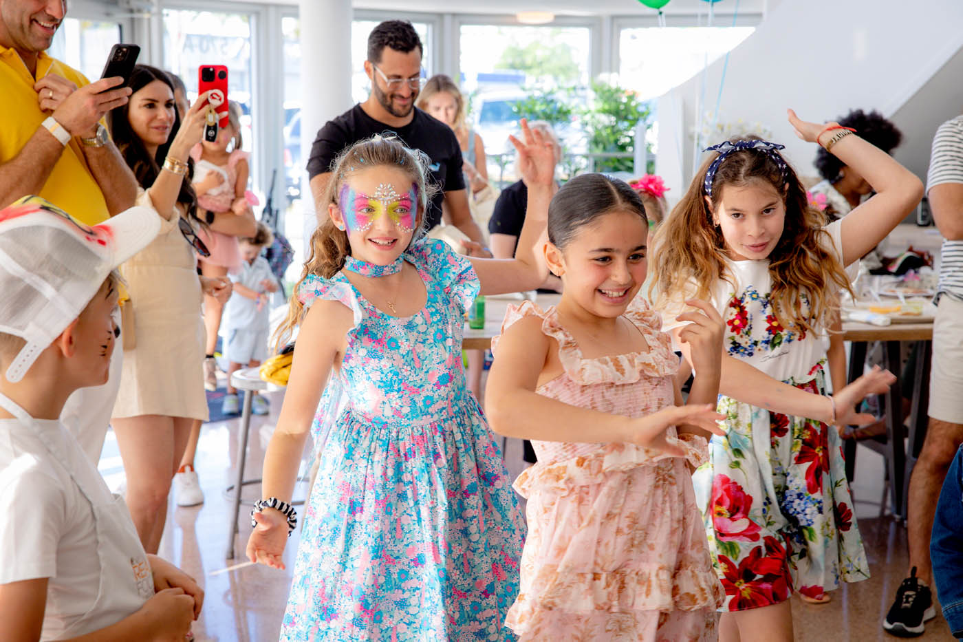 Little girls wearing butterfly masks at The Real Food Academy Tampa's kids birthday pary place.