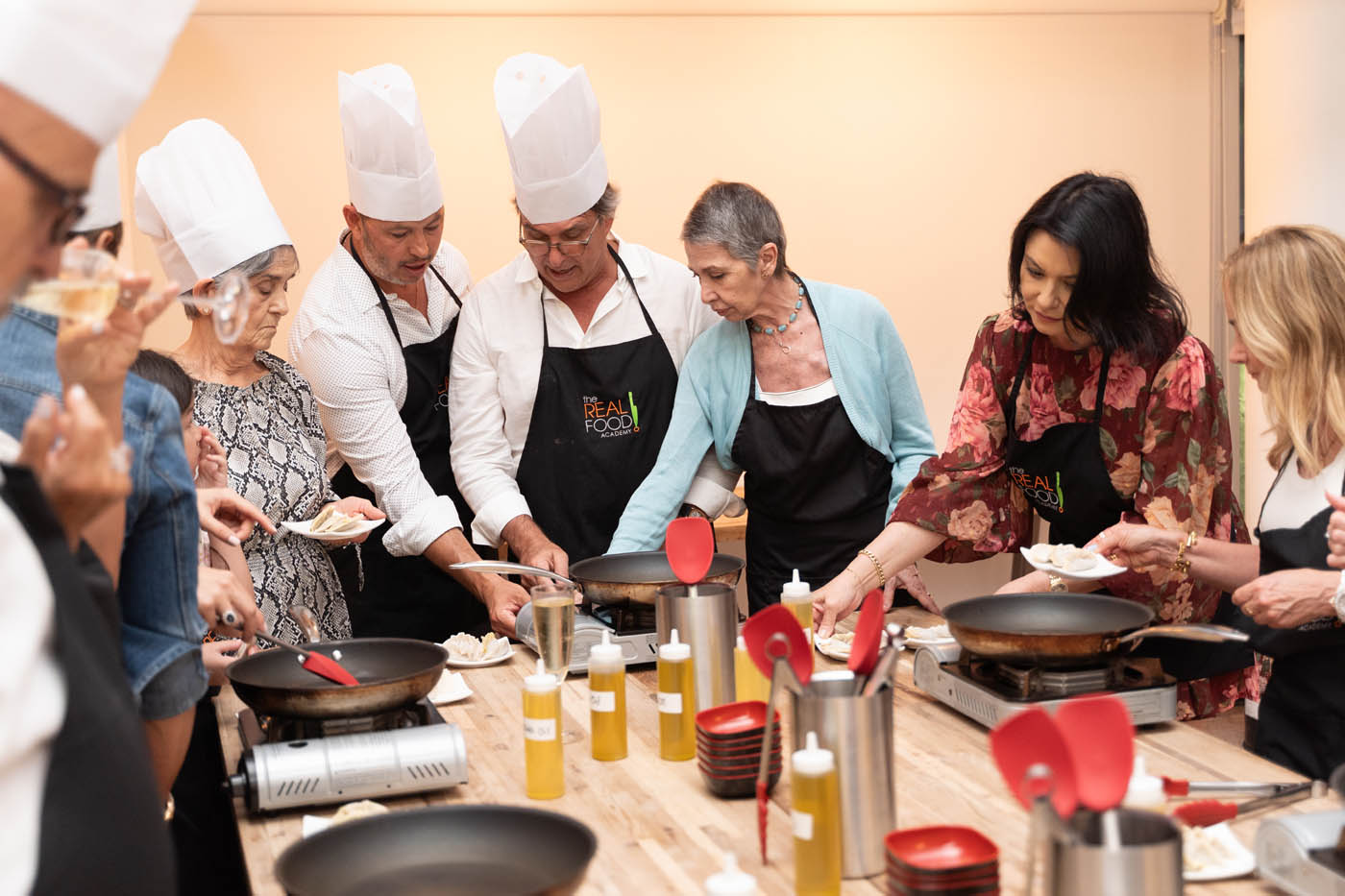 A group of team members cooking their meal led by our The Real Food Academy chef, check out our corporate party venues in Tampa, FL.