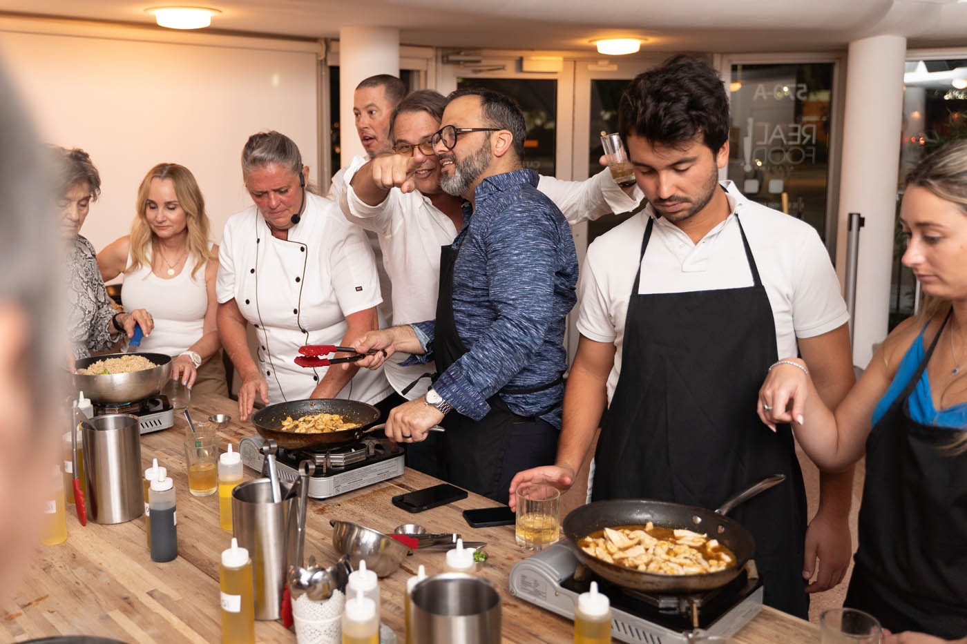 A group of team members drinking and laughing at The Real Food Academy's corporate party venue in Tampa, FL. 