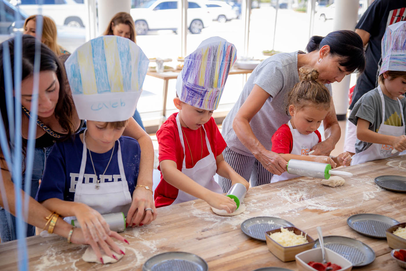 A group of children learning to cook during an indoor birthday party - Contact The Real Food Academy to book one of the best indoor birthday party places in Tampa, FL.