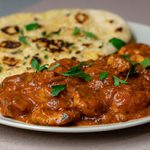 The Real Food Academy Tampa chicken tikka masala with a side of naan.