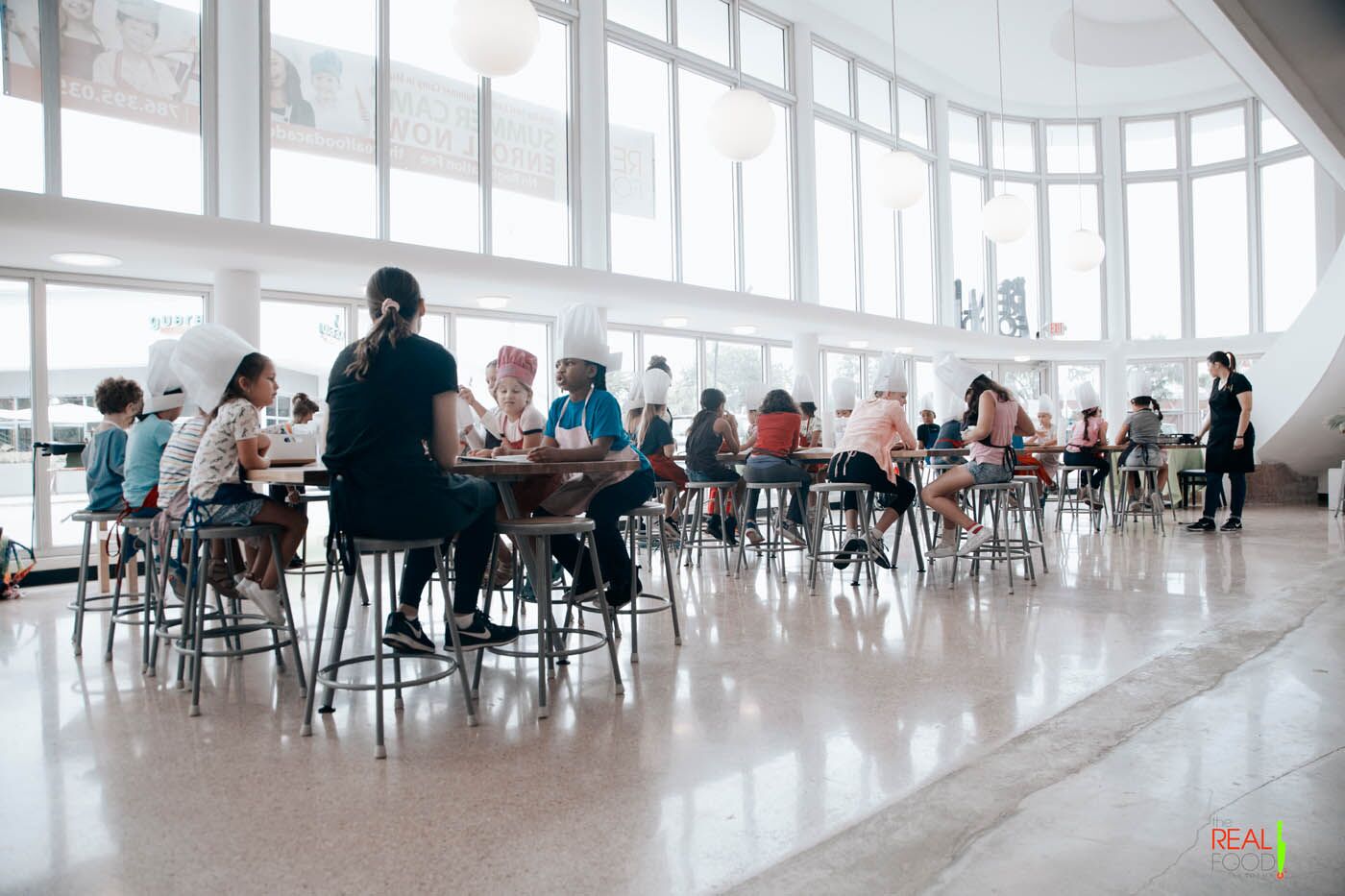 A goup of kids and teens at The Real Food Academy's after school program, learning healthy smart food choices.