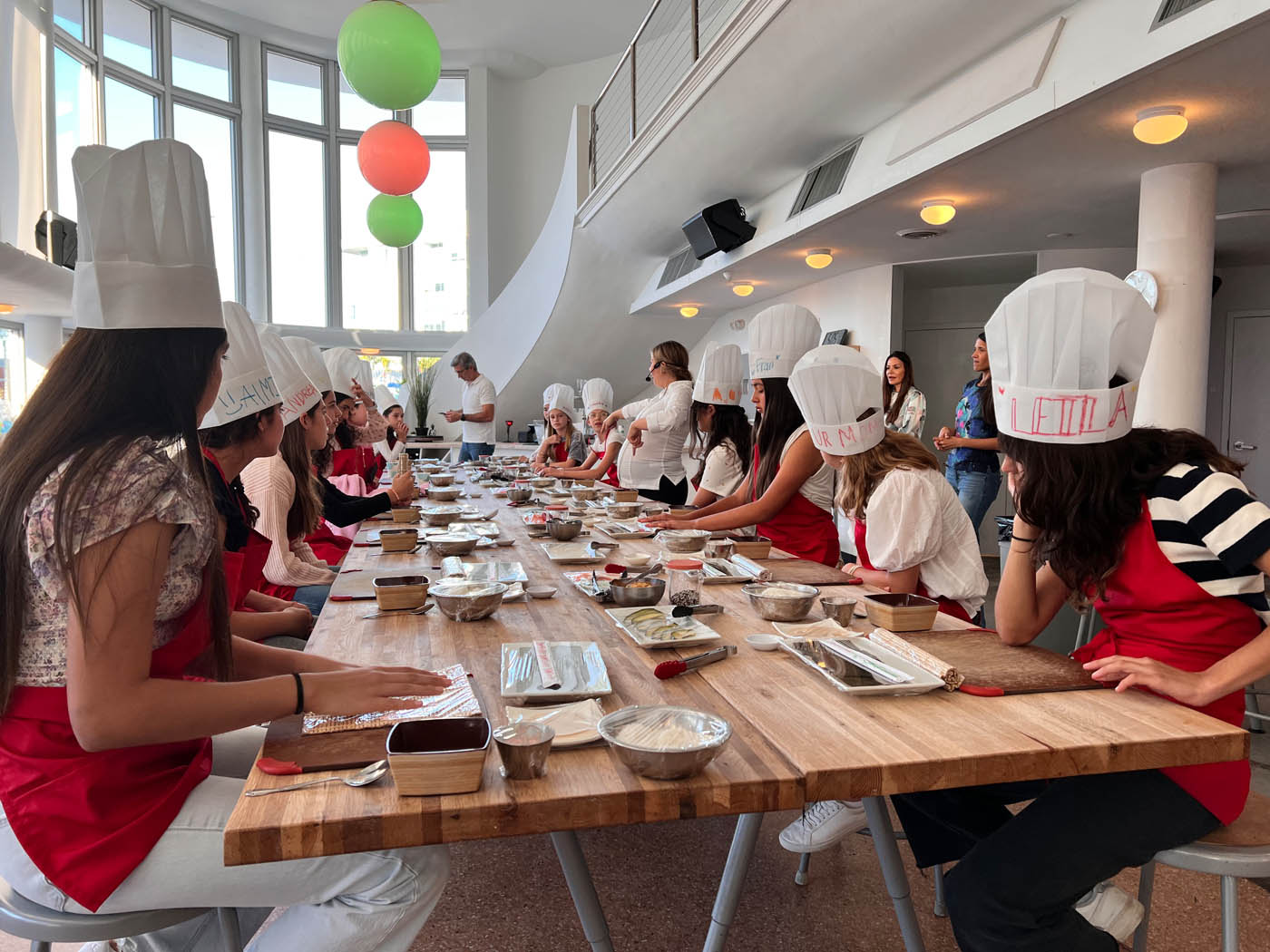 A little girl with a The Real Food Academy apron, a birthday party venue in Tampa, FL.